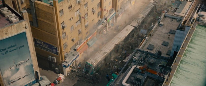 Aerial view of train stopped in middle of street.