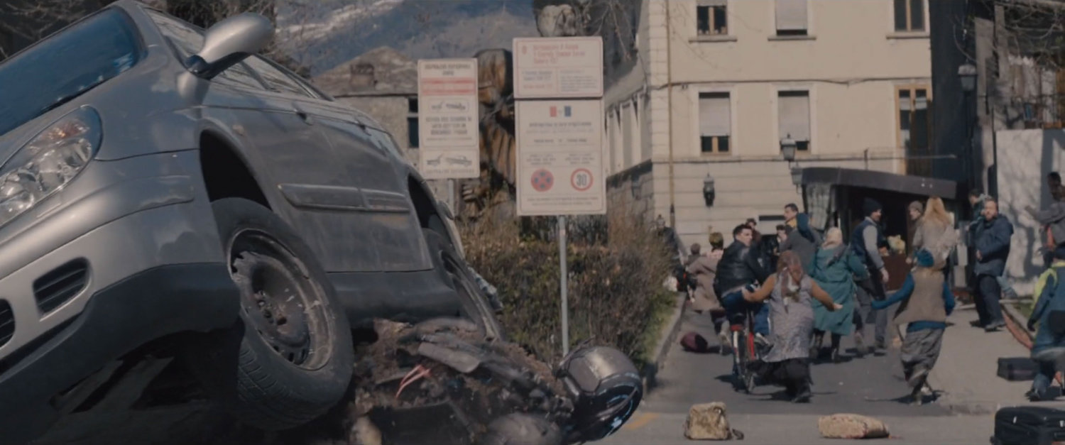 Civilians run from Ultron drone near a parking lot.