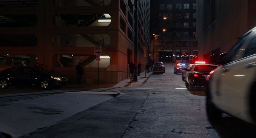 Police cars race up San Francisco street.
