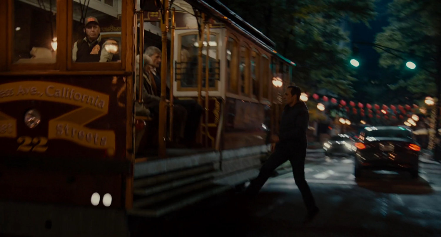 Scott steps onto street car.