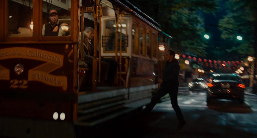 Scott steps onto street car.