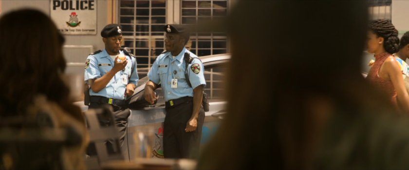 Two police officers in front of a Lagos police station.