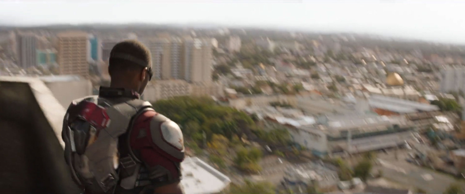 Sam standing on a rooftop in Lagos, surveying the city.