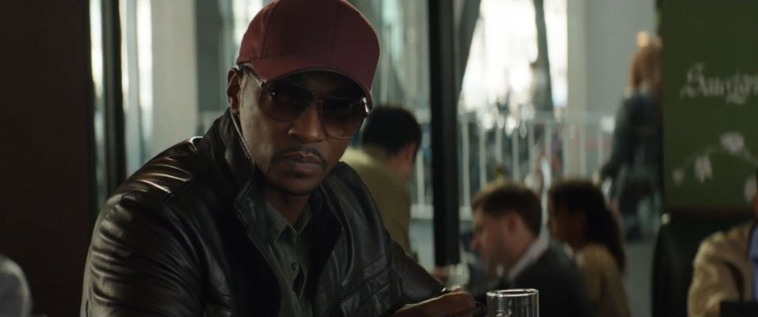 Sam Wilson in disguise sitting at a bar.
