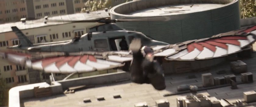 The Falcon flies towards a helicopter hovering over a rooftop.