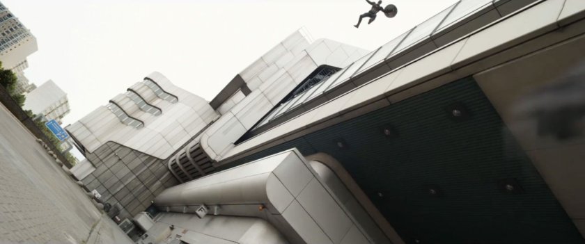 Captain America leaps off the side of a large industrial looking building.