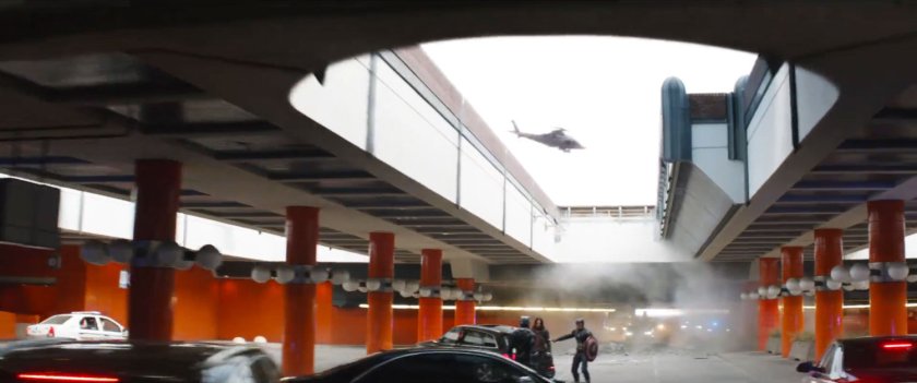 Bucky Barnes, Captain America, and Black Panther on a cobblestone road underneath an overpass.