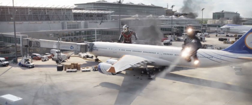 Giant-Man behind a 747 airplane on the Leipzig/Halle Airport tarmac.