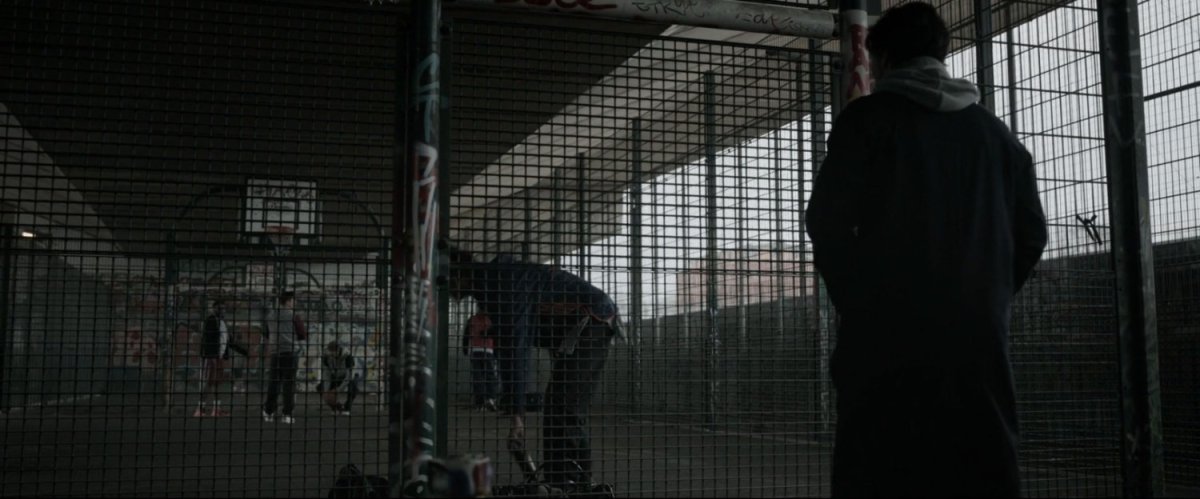 Stephen Strange confronts Jonathan Pangborn at an urban basketball court.
