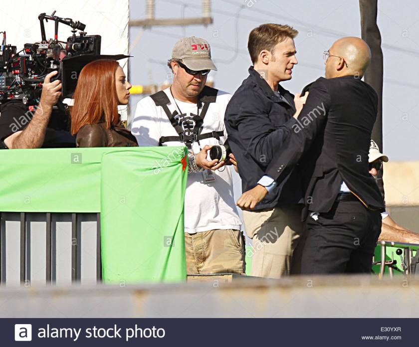 Stock photo, behind the scenes of Chris Evans and Scarlet Johansson filming rooftop scene with green screen.