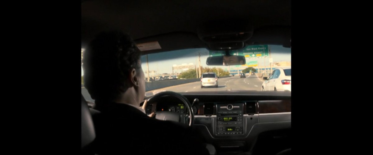 POV from backseat of car being driven by Happy Hogan on Long Island Expressway.