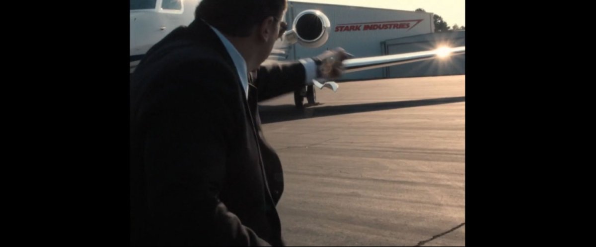 Happy Hogan walking towards a Stark private jet.