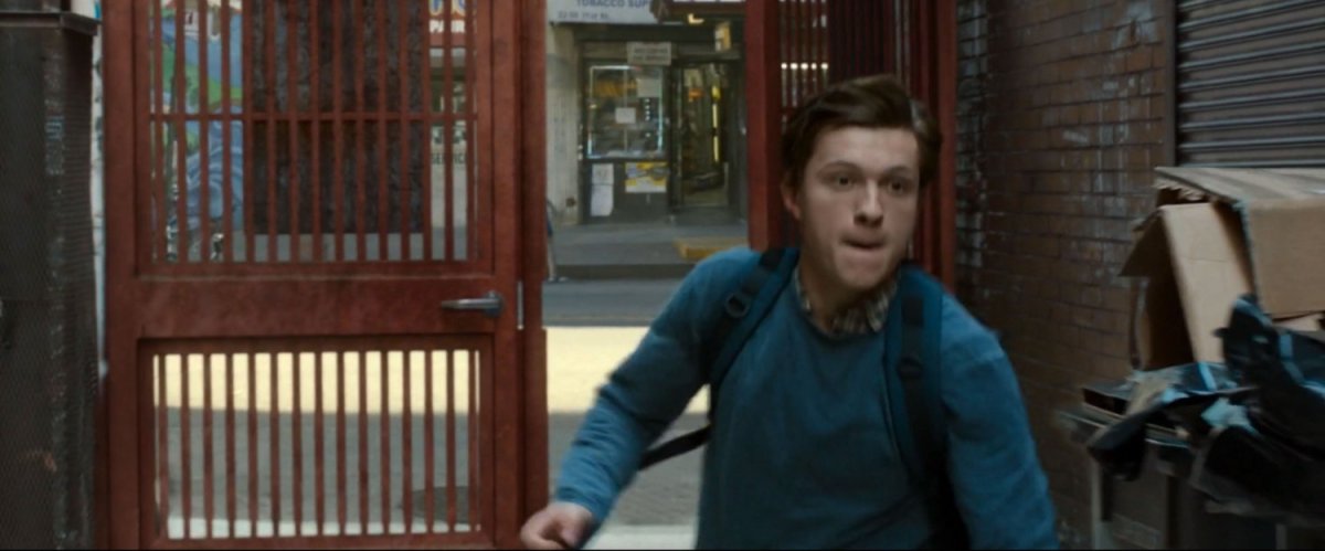 Peter runs into a gated alley.