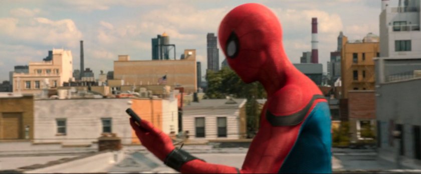 Spider-Man looking at his phone with Queens in background.