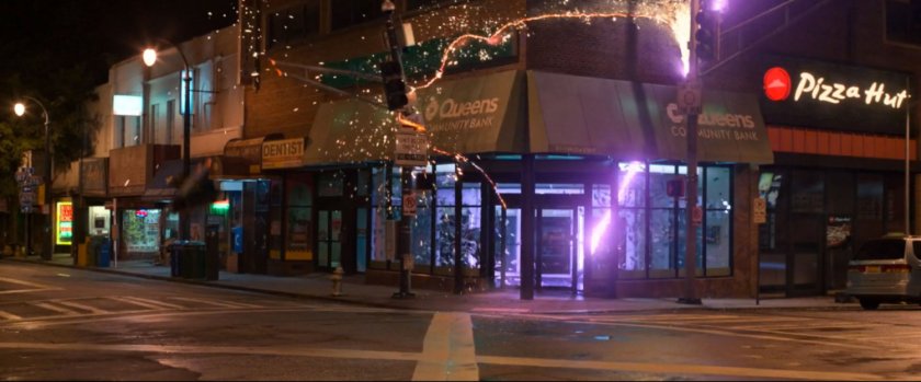 Exterior of Queen Community Bank on corner of 21st Street with sparks shooting from building.