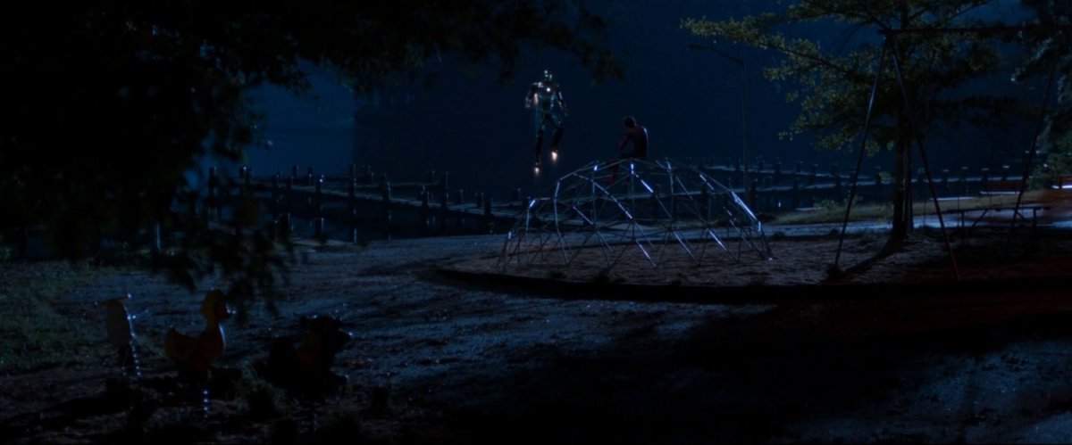 Iron Man hovers over playground talking to Spider-Man.