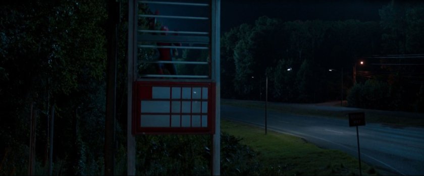Peter hiding in the sign at a derelict gas station.