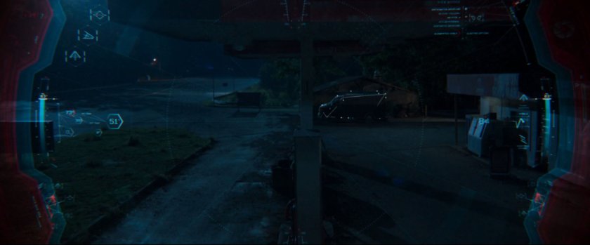 Peter spies on a van at a derelict gas station.