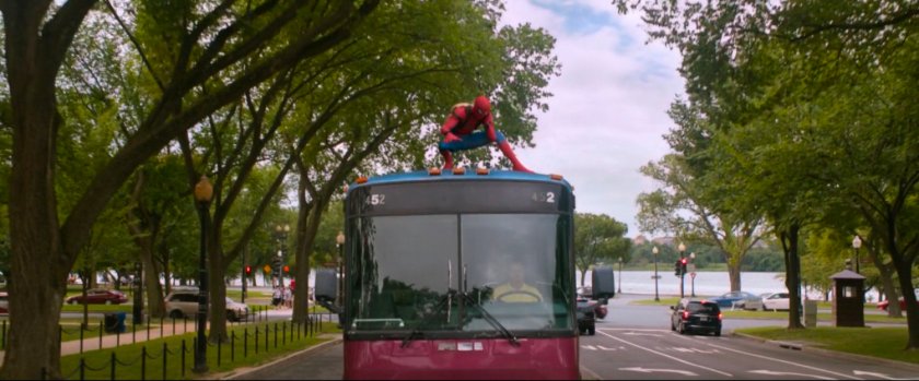 Spider-Man on top of tour bus.
