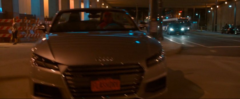 Car with no headlights on driving on New York street.