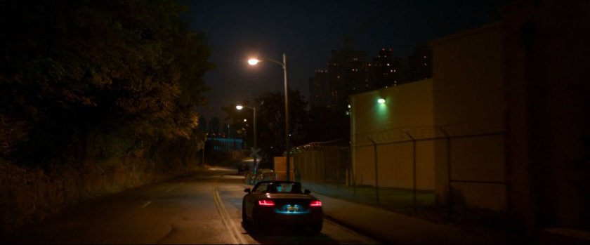 Car on road outside fenced area for Toomes' warehouse.