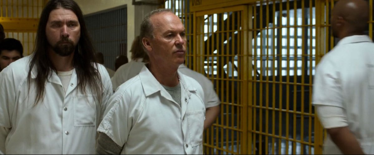 Adrian Toomes walking down a prison hallway.