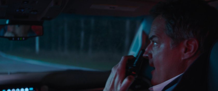 Director Hayward on walkie talkie in car.