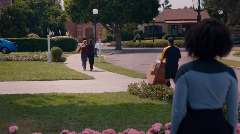 Monica observing Wanda and Agnes walking away on the sidewalk.