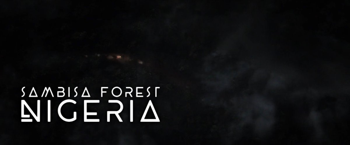 Aerial view of forest at night time. Text: Sambisa Forest Nigeria.