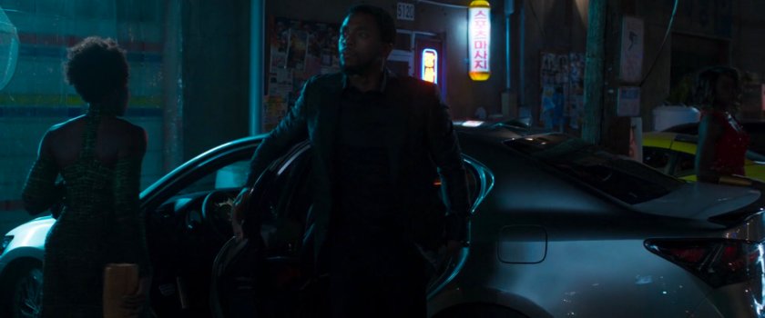 T'challa exiting a car in a dark alley.