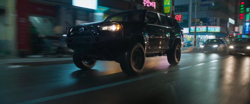 Close-up of SUV racing along Busan street.