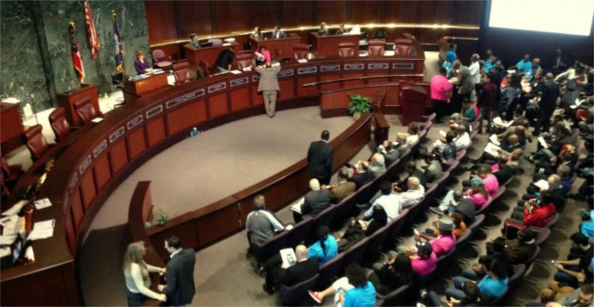 Google street view of the Atlanta City Hall with audience members in chairs.