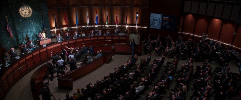 A crowd inside the United Nations listen to T'challa make a speech.