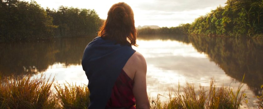 Rear view of Bucky barnes looking out over Wakandan lake.