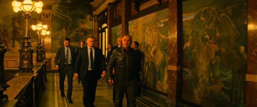 Men walk through hallway of a Russian hotel.