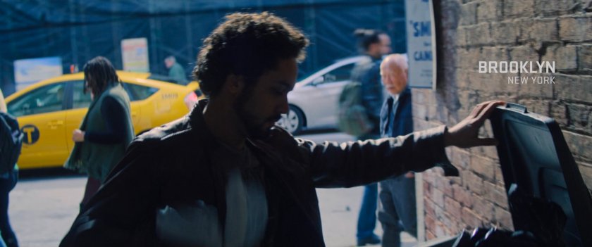 Unique putting trash in a trash can. Text: Brooklyn, New York.