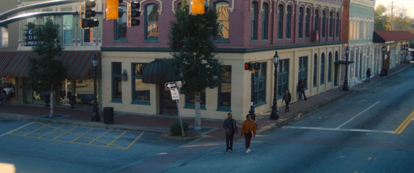 Sam and his sister cross the street outside the bank.