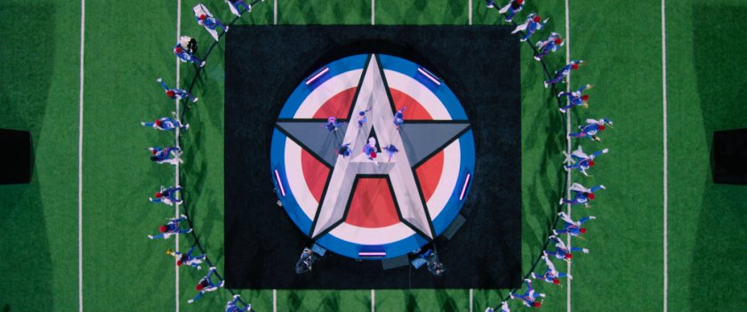 Aerial view of large 'A' logo on center of football field.