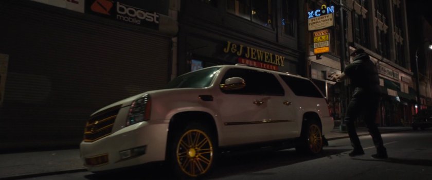 White SUV parked in front of X-Con Security Consultants.
