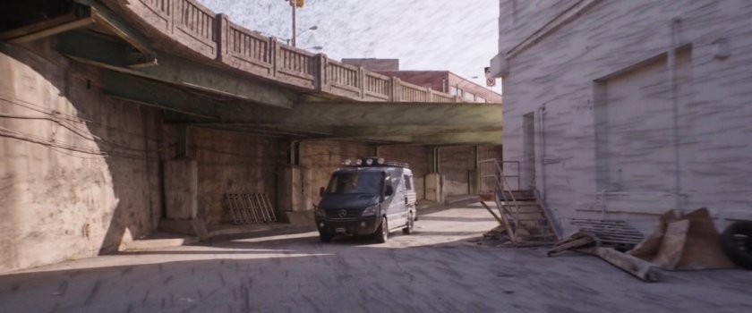 The van drives into an alley.