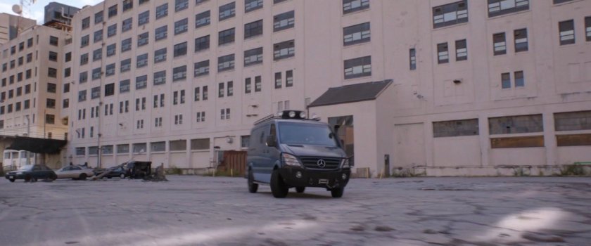 Hank's van behind an industrial building.