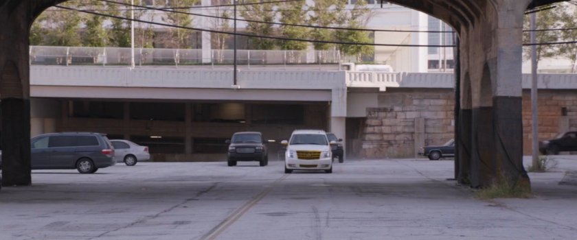 Vehicles pulling up to industrial area.