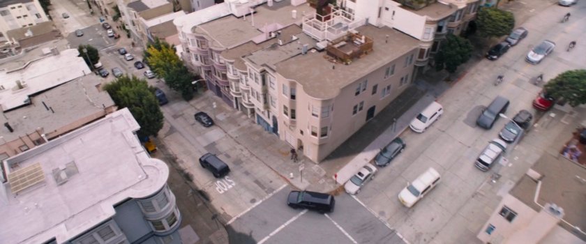Aerial view of SUVs chasing van on San Francisco street.