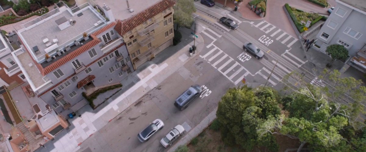 Aerial view of van heading towards intersection.