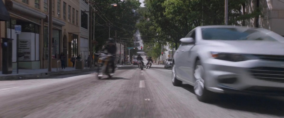 Motorcycles join the pursuit on a San Francisco street.
