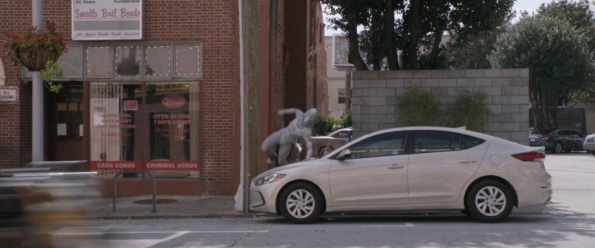 The Ghost leaps over a parked car.