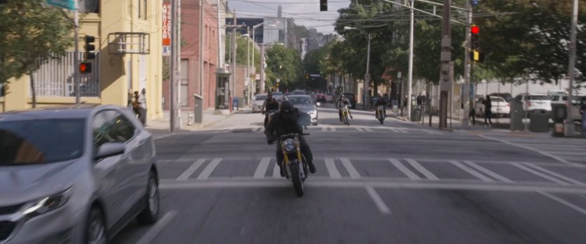 Motorcycle riders crossing through intersection.