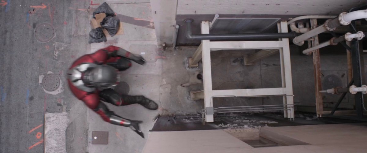 Aerial view of Giant-Man entering alley.