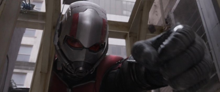 Giant-Man reaching into alley.