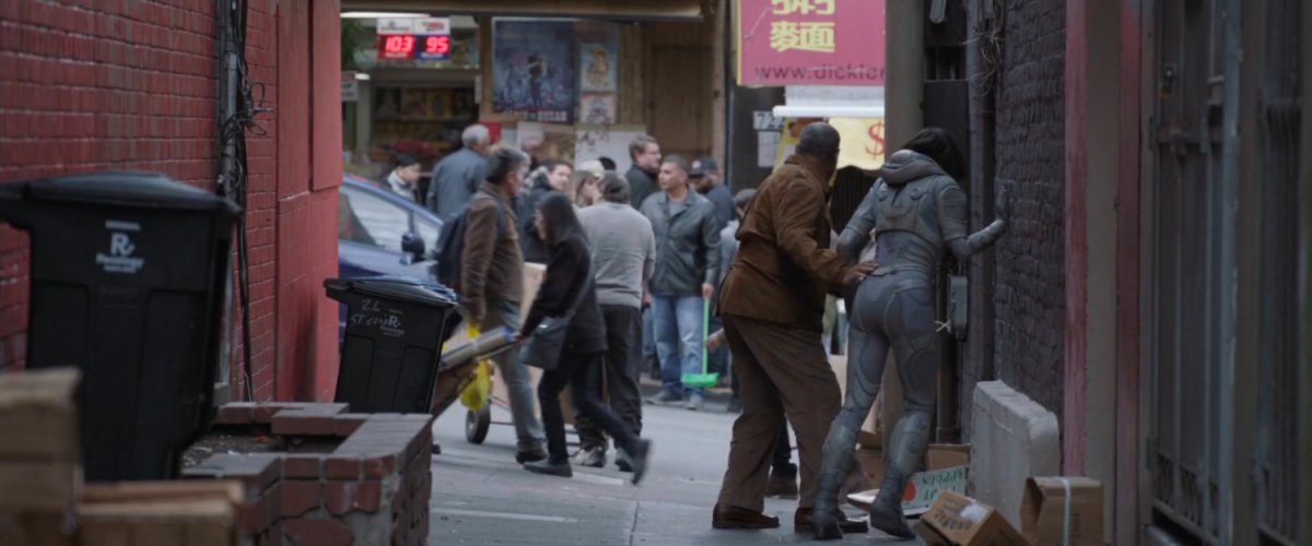 View of busy Chinatown street from an alley.
